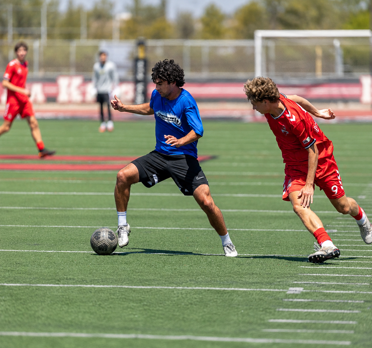 Men's team athlete dribbling past a defender