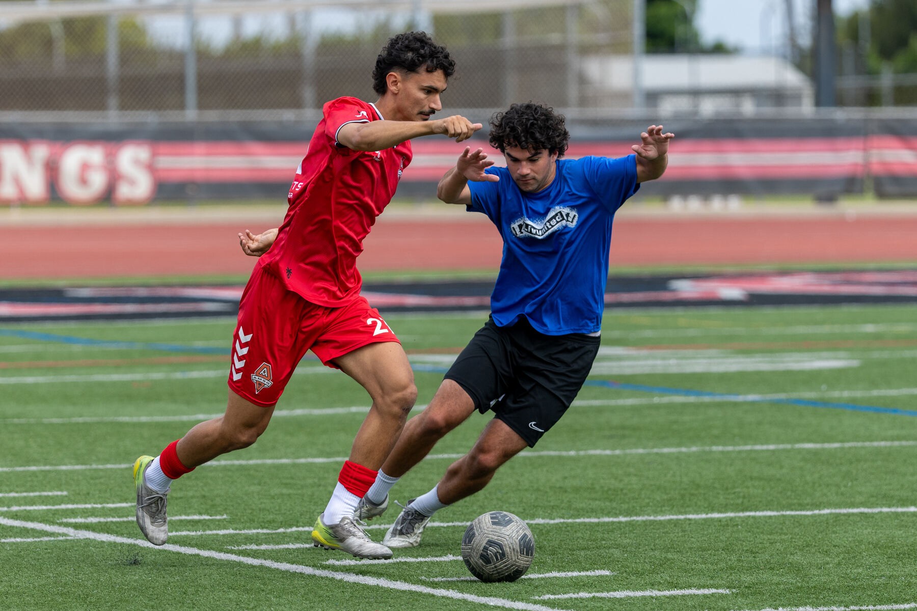 Men's athlete dribbling past a defender