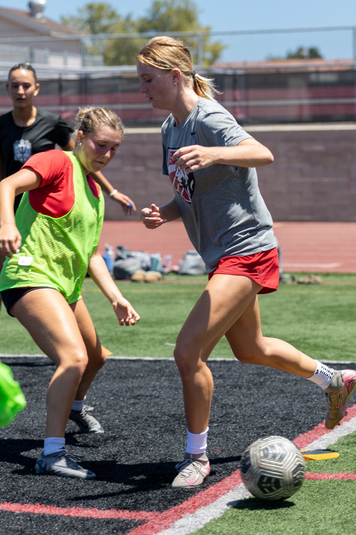 Women's athletes competing for the ball during a match