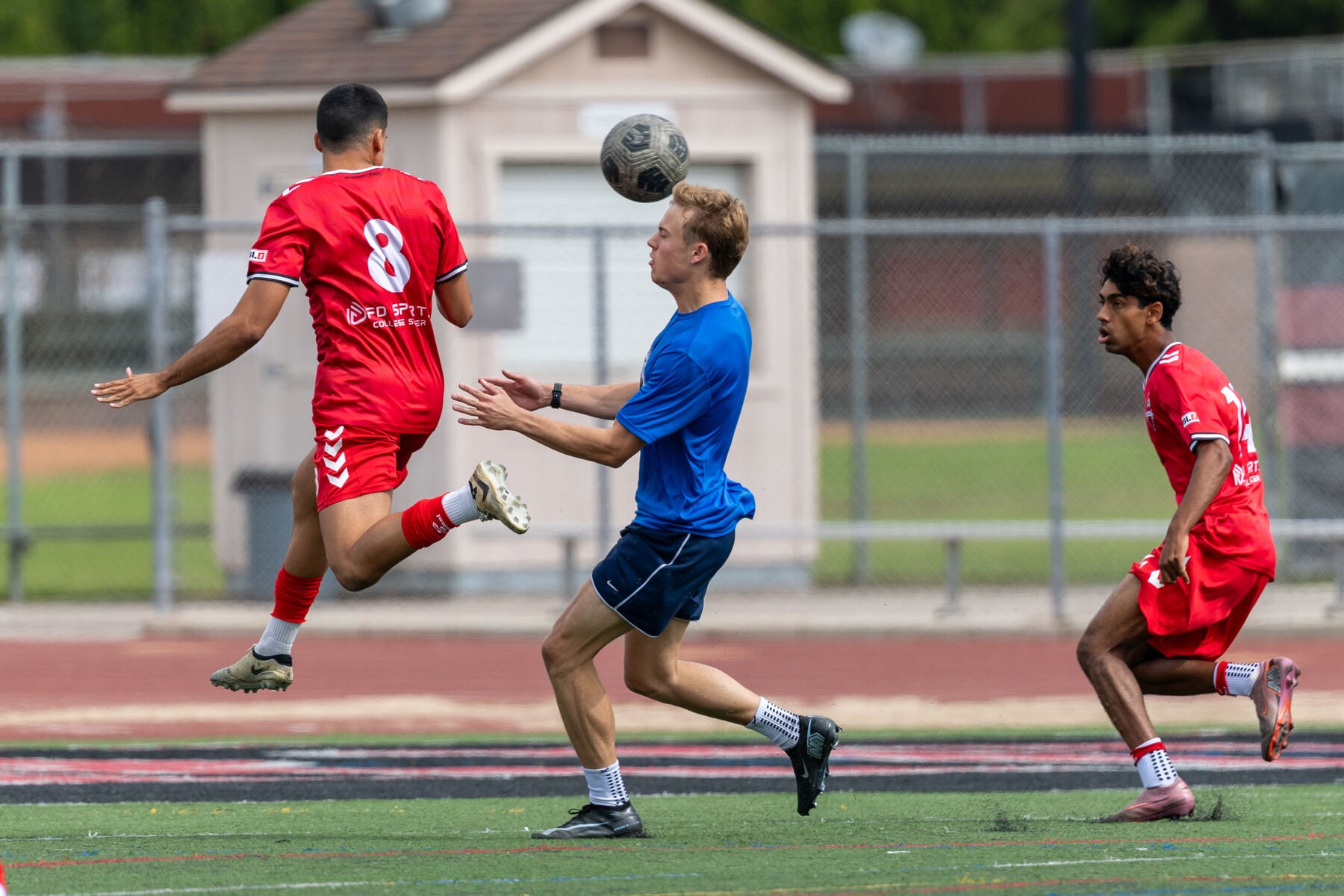 Athlete controlling the ball mid-air during a match